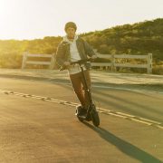 Segway KickScooter P65 Lifestyle picture Horizontal Man riding on road sunset