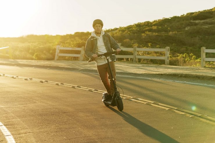 Segway KickScooter P65 Lifestyle picture Horizontal Man riding on road sunset